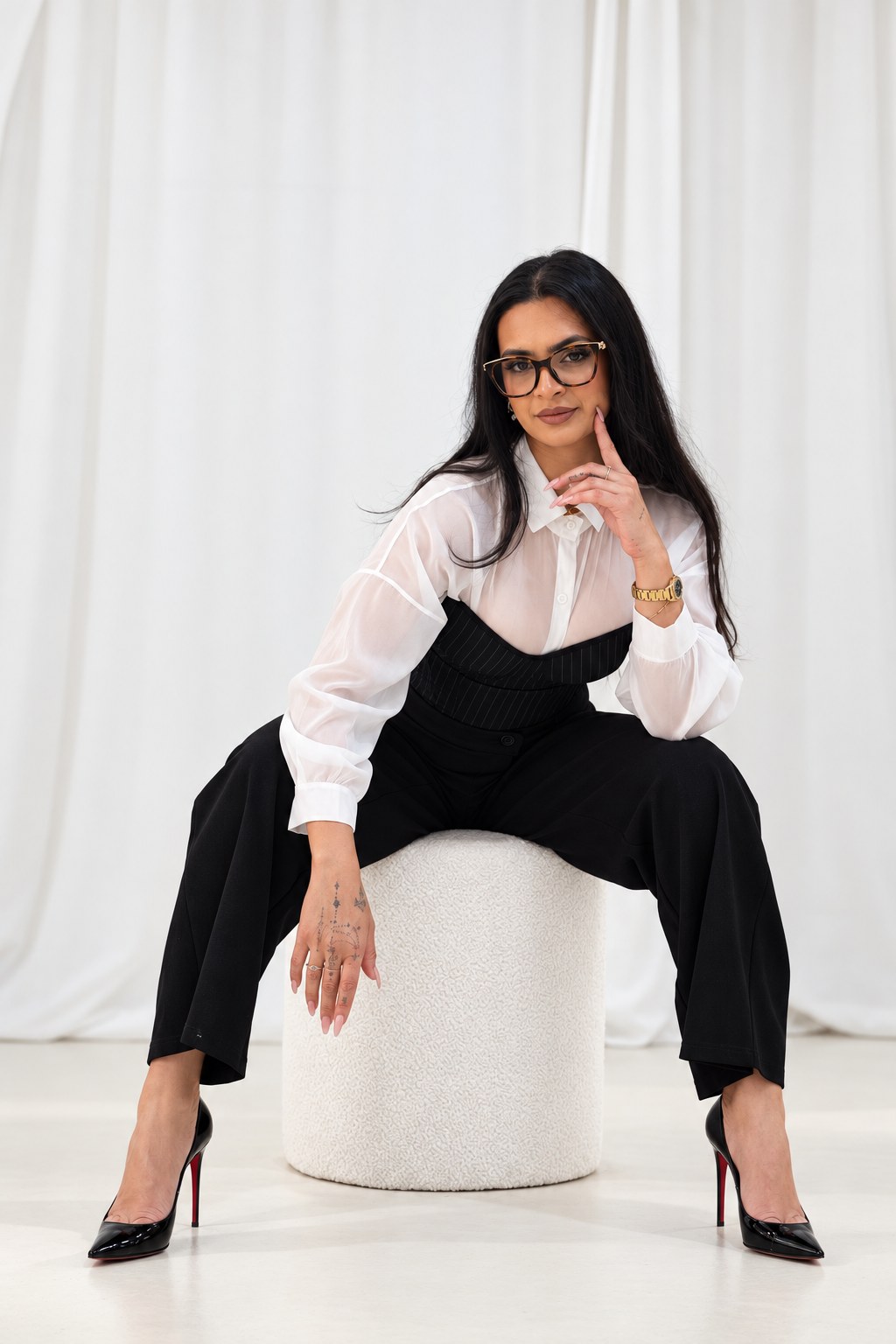 Portrait on a boucle stool against white drapery